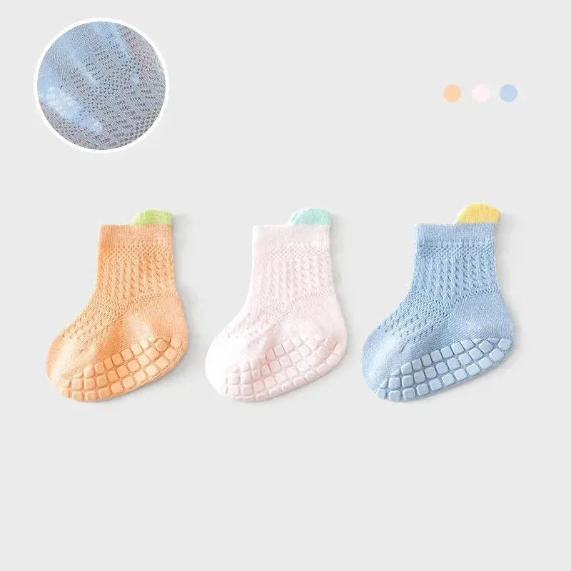 Set of 3 pairs of SHOPEZRA L.L.C. baby girl cotton socks with colorful non-slip grip, breathable mesh design for infants and kids.
