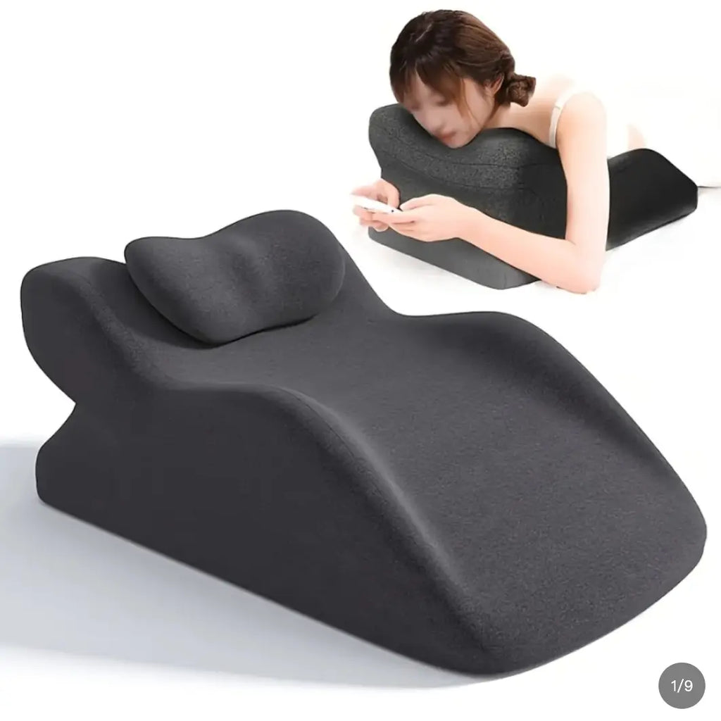 Supportive stomach sleeper pillow for comfortable face-down reading and relaxation.