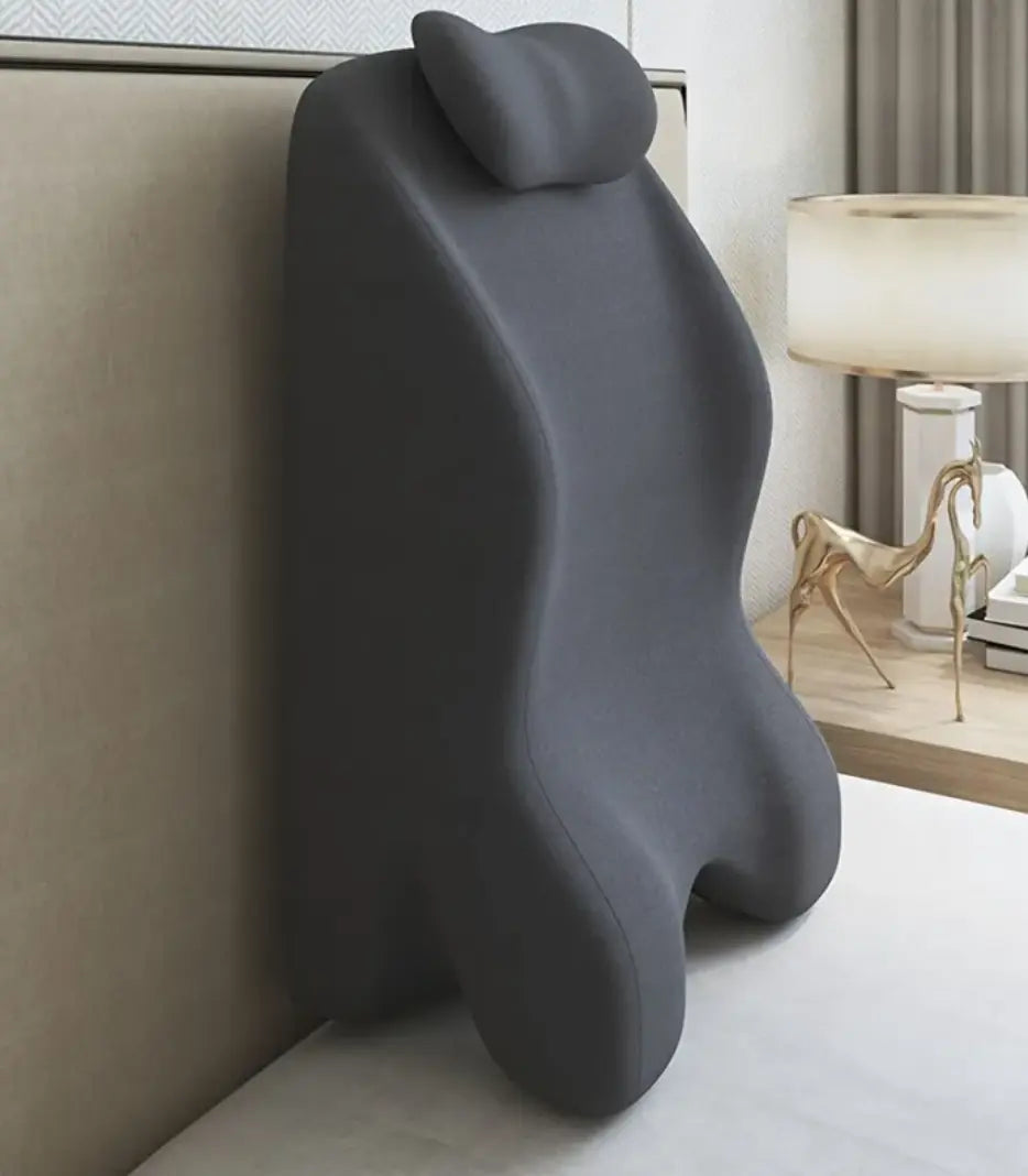 Supportive stomach sleeper pillow for optimal comfort and support while lying face down on a bed.