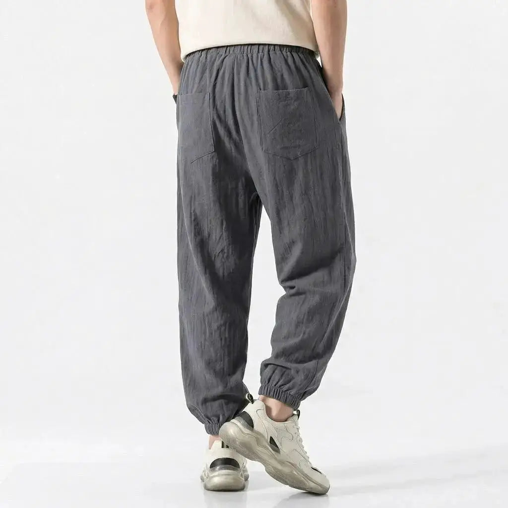 Green men's cotton linen harem trousers with drawstring, loose fit, casual streetwear style for gym, daily wear, and work.