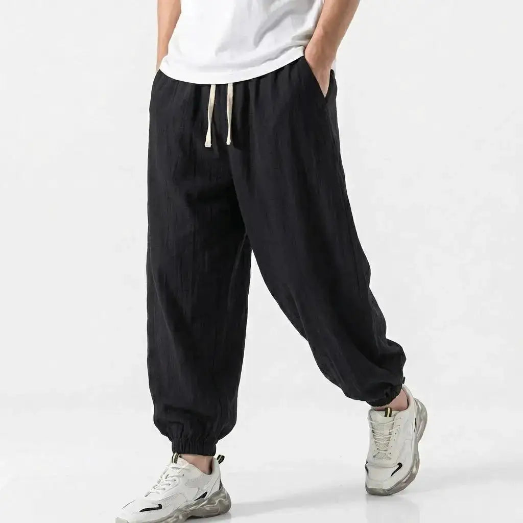 Green men's cotton linen harem trousers with drawstring, loose fit, casual streetwear style, suitable for gym, daily wear, and work.