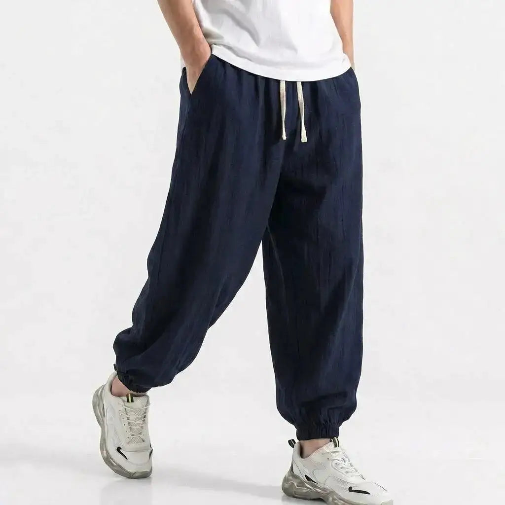 Mens green cotton linen harem trousers with drawstring, loose fit, baggy bottoms, casual streetwear for gym and daily wear.