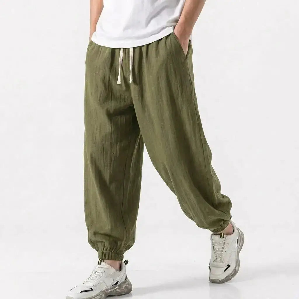 Green men's cotton linen harem trousers with drawstring, loose fit, casual streetwear style for gym or daily wear.