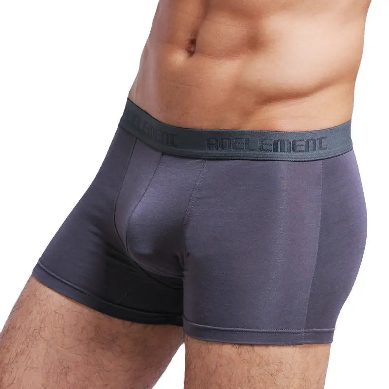 Grey men's U-convex mid-waist boxer underwear by SHOPEZRA L.L.C., breathable, sweat-absorbing, with a sexy fit and comfortable design.
