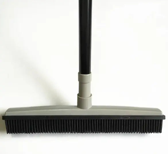 Pet hair removal broom for effective cleaning of carpets and floors, featuring a grey head and a durable handle.