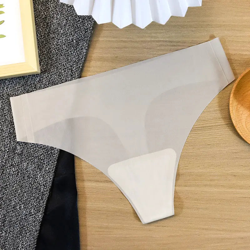Cream-colored women's seamless cotton thong underwear by SHOPEZRA L.L.C., designed for sports and fitness with antibacterial ice silk fabric.