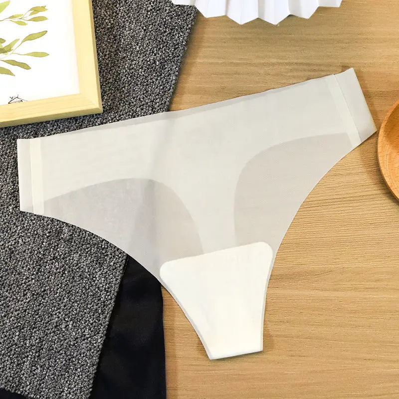 White seamless women's thong underwear by SHOPEZRA L.L.C., made of pure cotton and ice silk for comfort and antibacterial fitness wear.