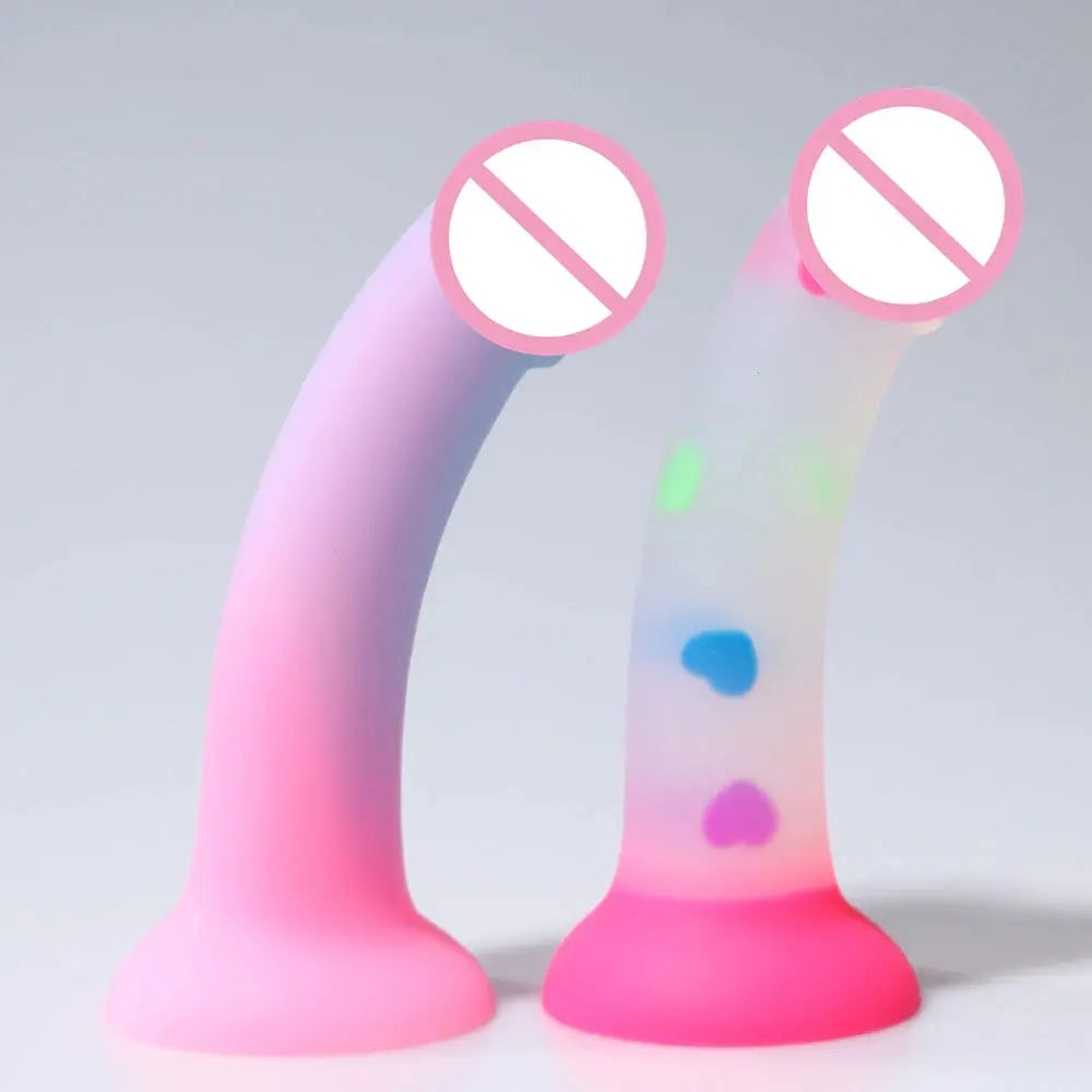 Luminous silicone female masturbation toy with realistic penis shape, skin-like texture, and suction cup for hands-free use.