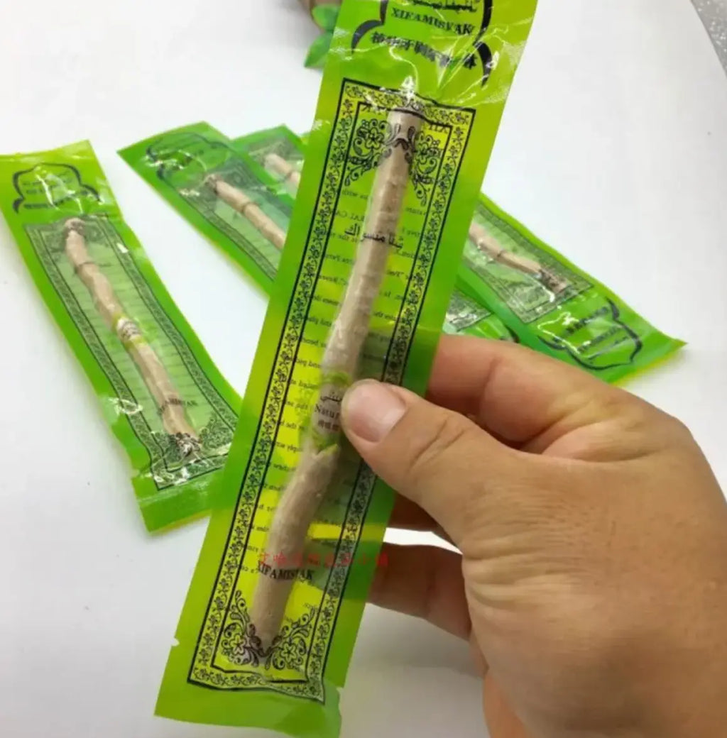 Natural Miswak tooth cleaning stick from SHOPEZRA L.L.C., showing the wooden stick used for traditional oral hygiene.