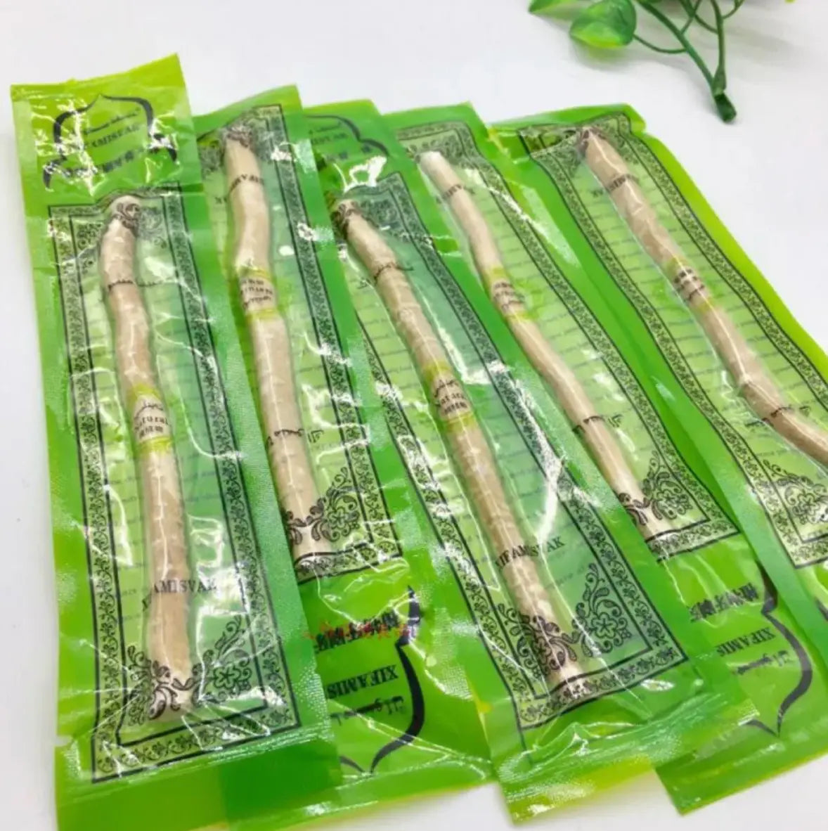 Natural Miswak tooth cleaning stick from SHOPEZRA L.L.C. with textured wooden surface and traditional design for oral hygiene.
