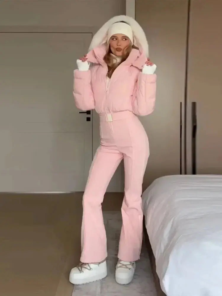 Pink women's fur collar hooded skiwear jumpsuit with high waist, zipper closure, and slim fit, ideal for winter outdoor activities.