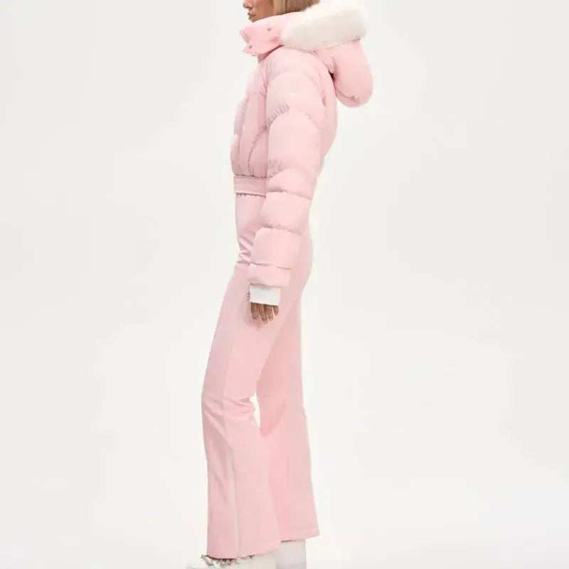 Pink women's fur collar hooded skiwear jumpsuit with zipper, high waist, slim fit, thick fabric, suitable for winter outdoor activities.