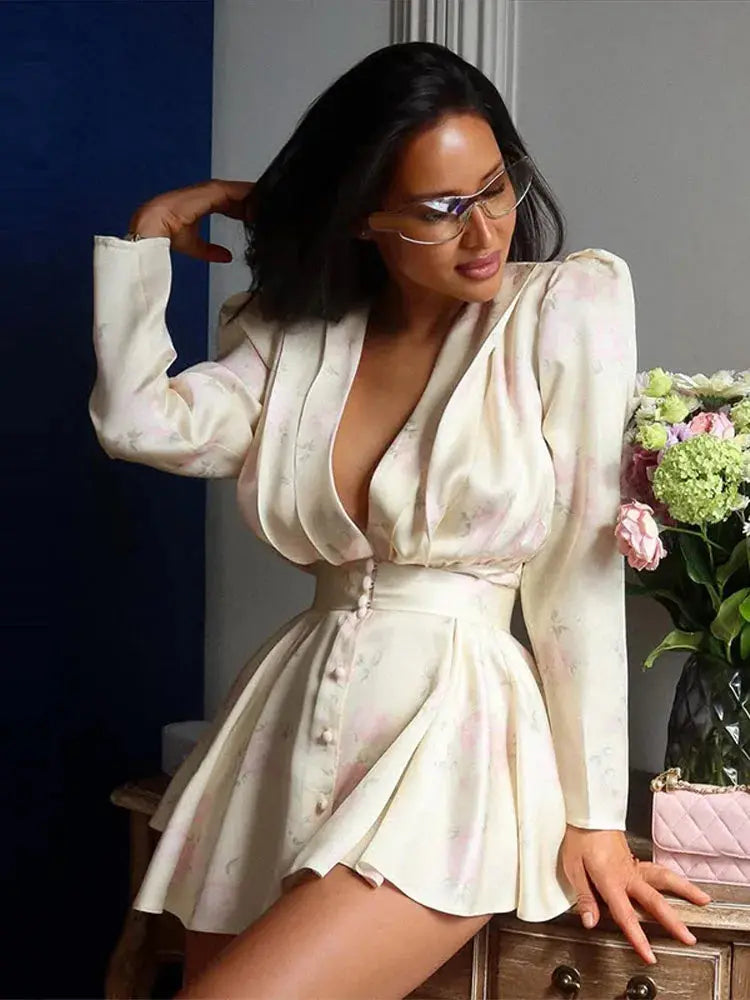Pink printed casual mini dress for women with full sleeves, V-neck, button front, and waist tape, perfect for spring and summer.
