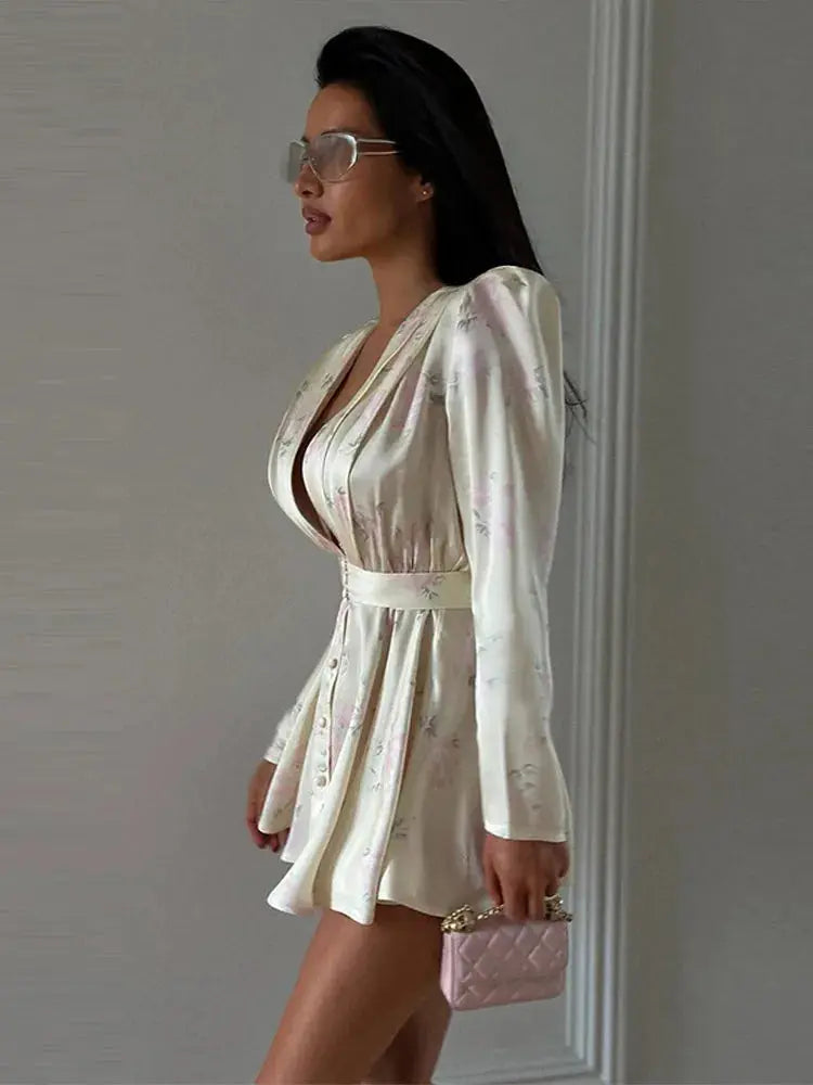Pink printed mini dress for women with full sleeves, V-neck, button front, waist tape, perfect for spring and summer beach wear.