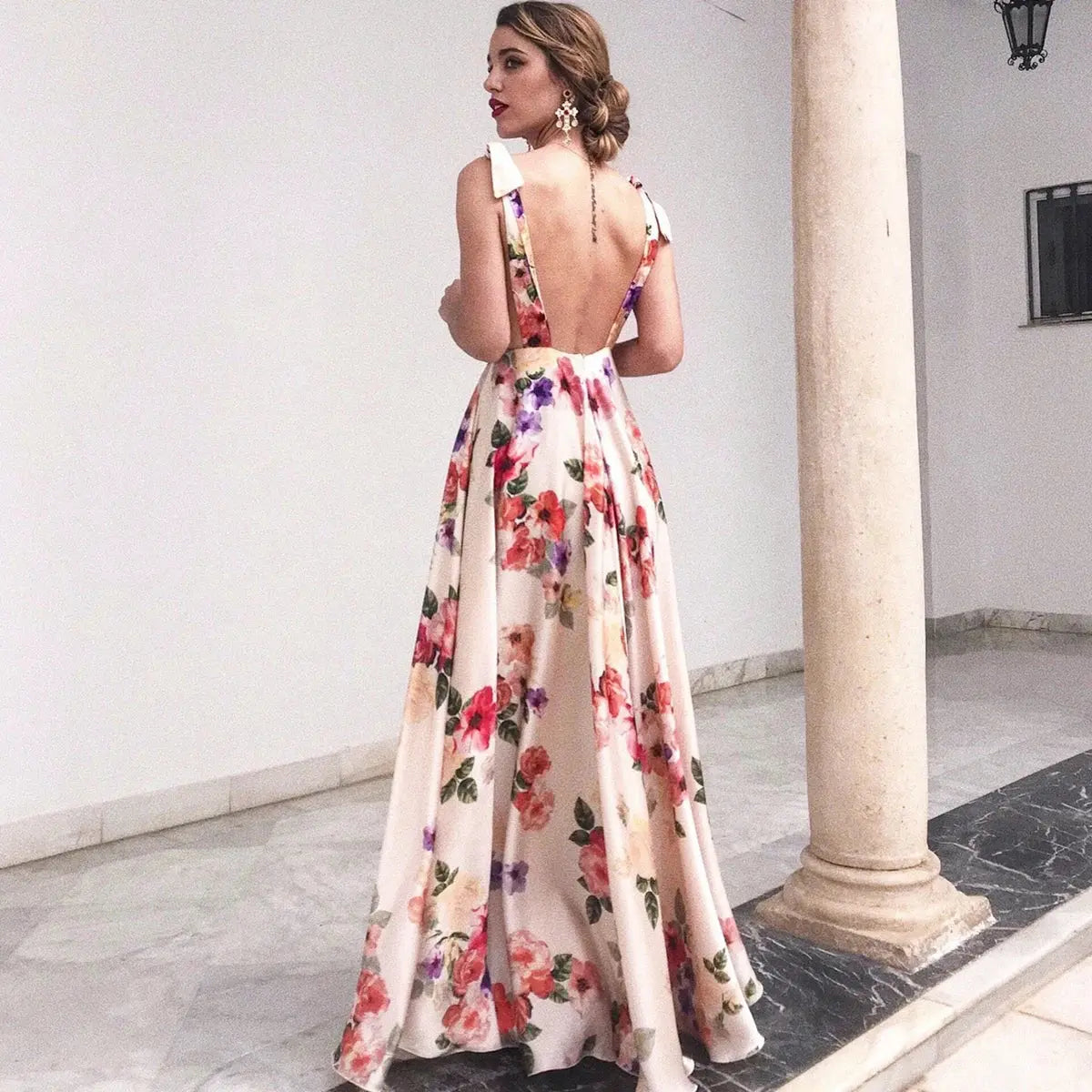 Pink boho style long beach holiday maxi dress with halter neck and floral print, perfect for summer women's fashion.