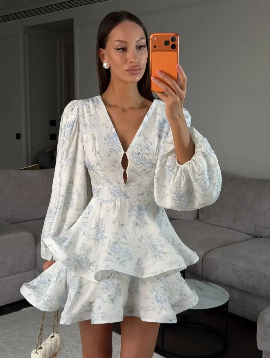 Elegant floral printed mini dress for women with waist cinch, pleated design, deep V-neck, long sleeves, and button front.
