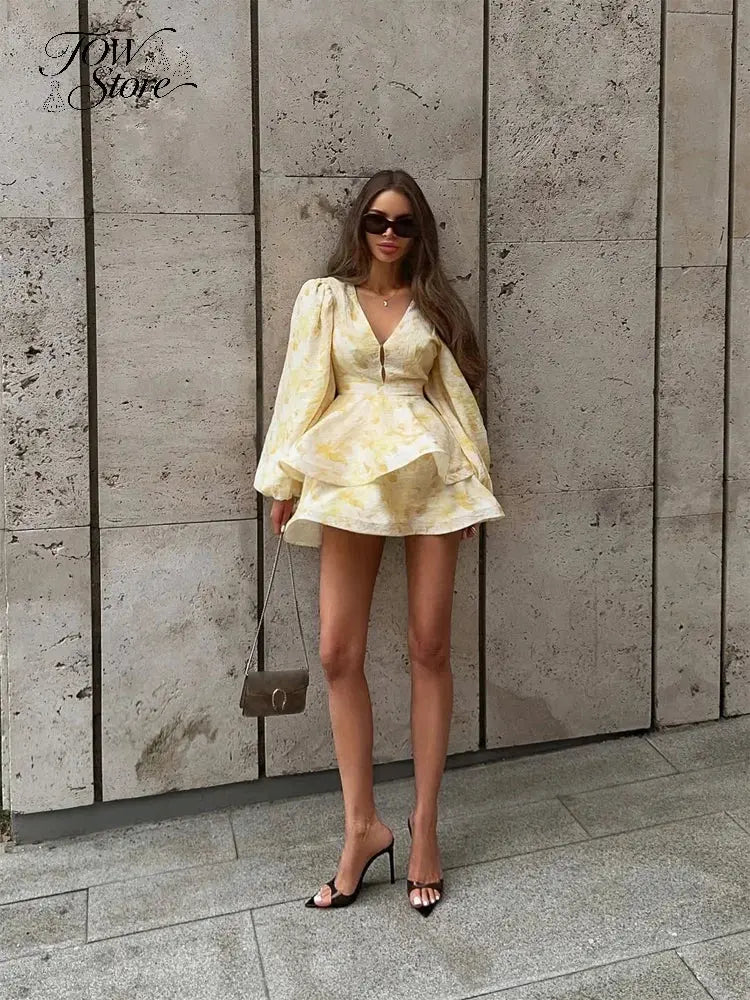 Elegant floral printed mini dress for women with waist cinch, pleated design, deep V-neck, long sleeves, and button front.