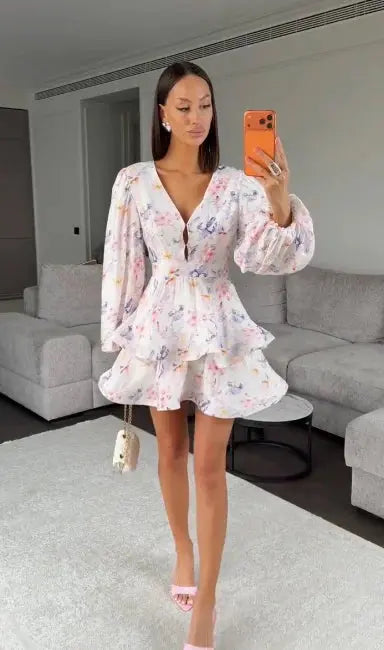 Elegant floral printed waist-cinched mini dress for women with pleats, deep V-neck, long sleeves, and button-front design.