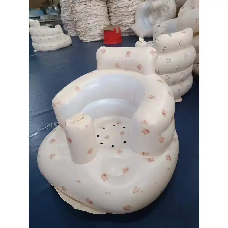Inflatable baby chair for dining and bath by SHOPEZRA L.L.C., featuring rainbow colors and soft, safe design for infants.
