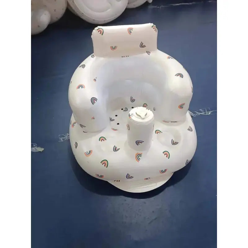 Inflatable baby chair by SHOPEZRA L.L.C. with rainbow design, suitable for dining and bath times, shown inflated and ready for use.