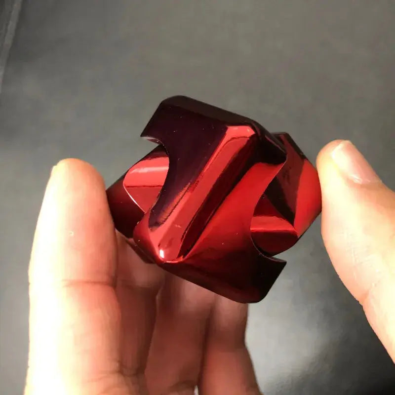 Colorful fidget spinner stress relief toy in a hand, featuring a shiny red metal design for stress relief.