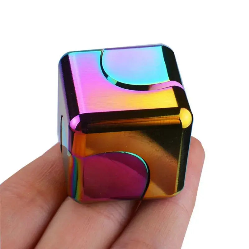 Colorful fidget spinner stress relief toy held in hand, showcasing its shiny metal design.