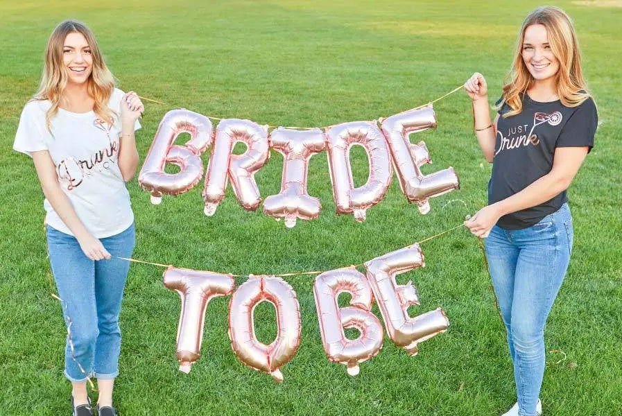 Rose gold 16-inch balloon banner with "Let's Flamingle" and other phrases, perfect for celebration decor.