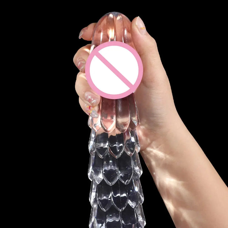Transparent dragon scale dildo with suction cup, anal and vaginal plug, designed for female pleasure and masturbation.