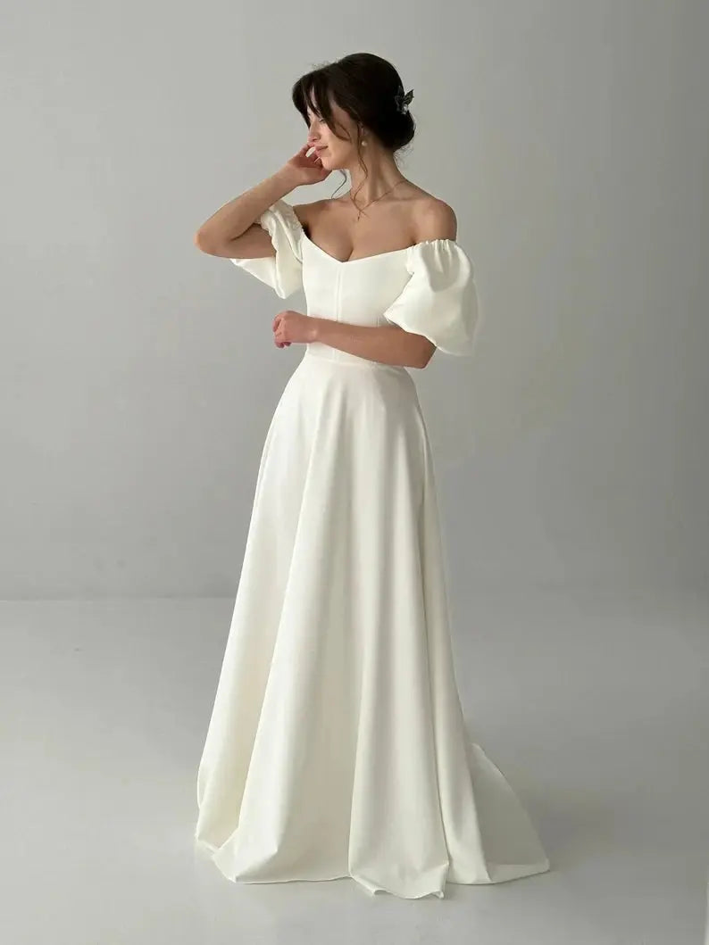 White ivory customized wedding dress with sleeves, fairy tale style, elegant one-line design by SHOPEZRA L.L.C.