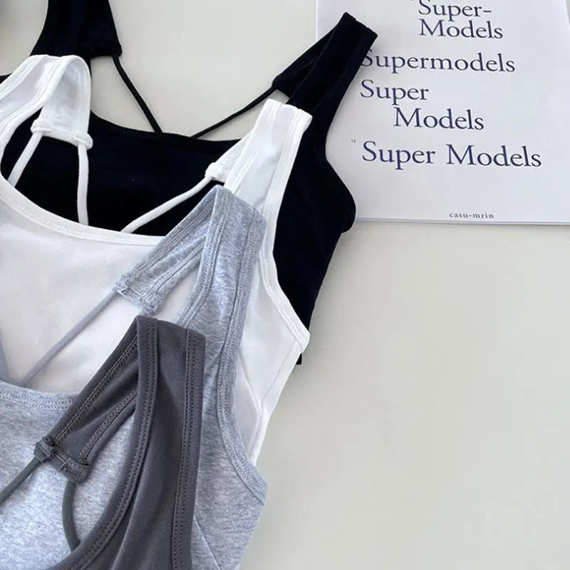 White all-in-one women's back underwear with inner camisole, breast pads, and open-back design, suitable for outdoor wear.