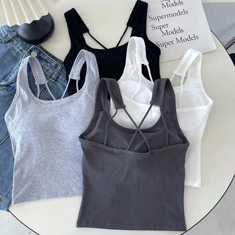 White all-in-one women's backless underwear with camisole and breast pads, designed for outside wear and revealing back.