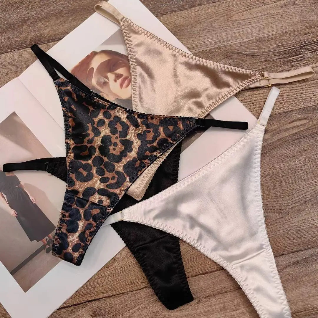 White women's thong underwear by SHOPEZRA L.L.C. with leopard print, satin seamless design, breathable cotton crotch, low waist style.