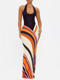 Halter Neck Maxi Dress with Abstract Print in vibrant orange and black stripes, perfect for special occasions.