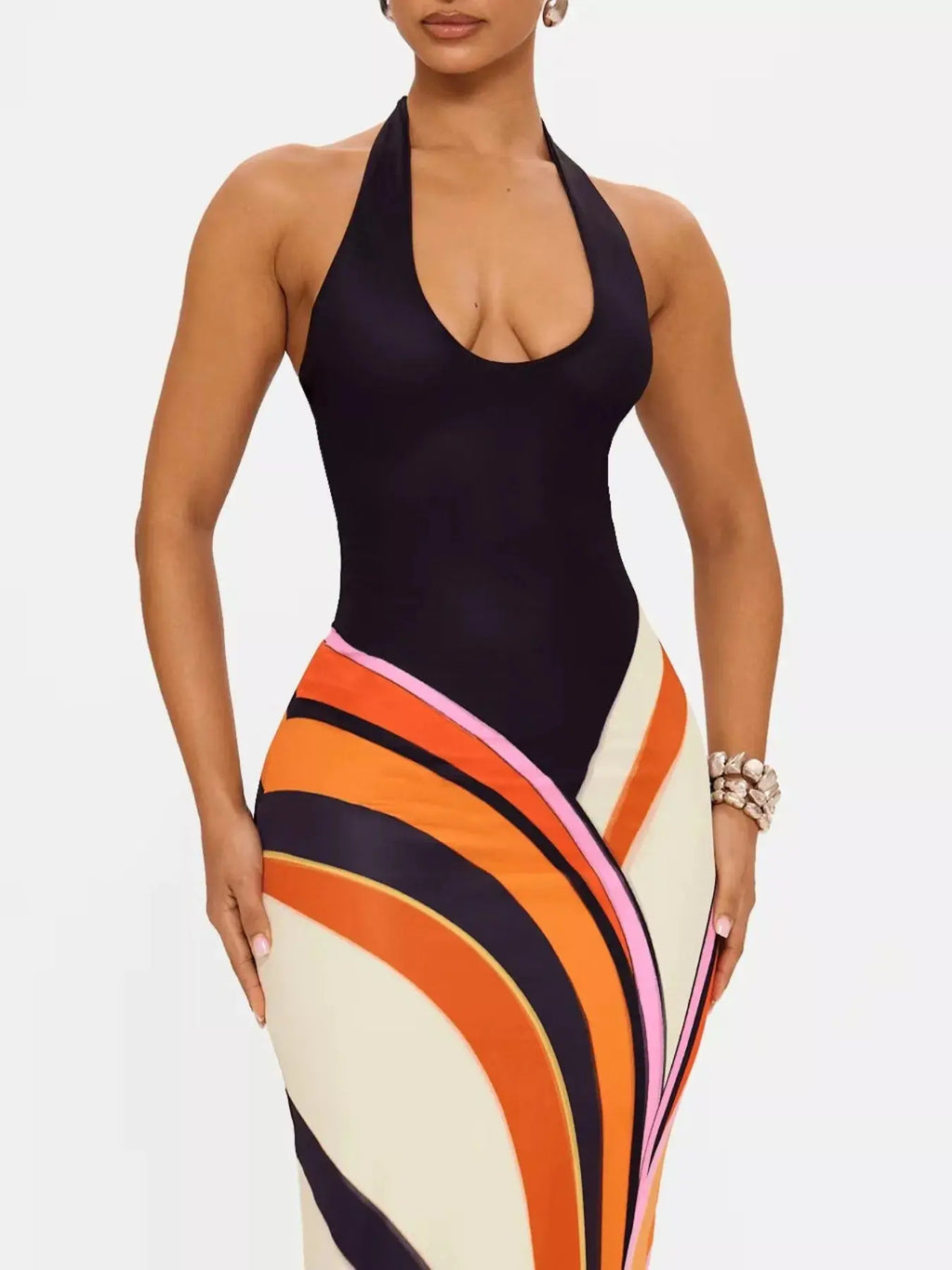 Black halter neck maxi dress with abstract print by Trendsi, featuring a flowing silhouette and stylish design.